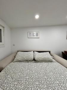 a bedroom with a bed with two pillows on it at AeroSuites202 Alojamiento Madrid in Madrid