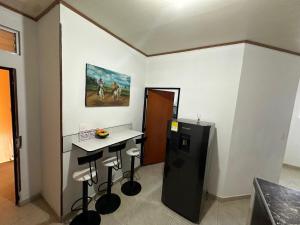 a kitchen with a counter and a refrigerator in a room at Apartamento Estadio 1 in Villavicencio