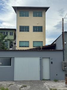 a tall building with a garage in front of a building at Nilza Melotti in Serra +28 photos