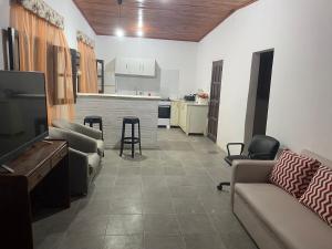 a living room with a couch and a table and a kitchen at DELPON Apart in Clorinda