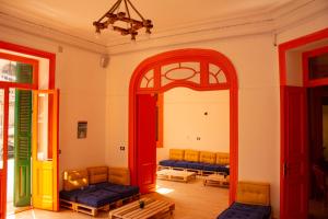 a room with two chairs and a mirror at Ithaka Raml Hostel in Alexandria
