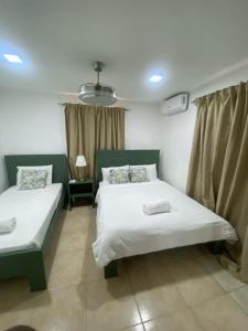 a bedroom with two beds in a room at Mila's House in La Romana