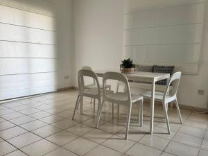 a dining room table and chairs with a plant on it at SWeET LEMON VILLA in Protaras +15 photos