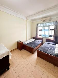 Postel nebo postele na pokoji v ubytování Nhà Nghỉ 14 Nguyễn Quyền