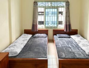 Postel nebo postele na pokoji v ubytování Nhà Nghỉ 14 Nguyễn Quyền