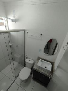 a bathroom with a toilet and a mirror at Apto Top Completo in Aracaju +41 photos
