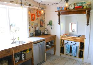 a kitchen with a sink and a counter top at Leven St Cottage in Naseby
