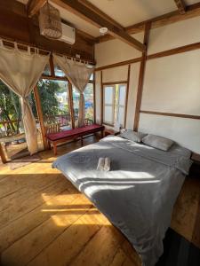 a bedroom with a bed in a room with windows at MAMA's House Mộc Châu in Mộc Châu +98 photos