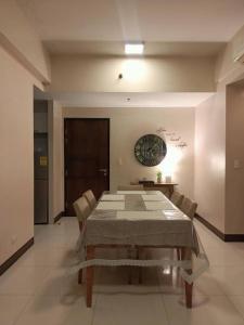 a large dining room with a table and chairs at Mactan Newtown in Lapu Lapu City