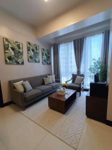 a living room with a couch and a coffee table at Mactan Newtown in Lapu Lapu City