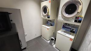 a small room with a microwave and a refrigerator at Hotel Royal Garden Kisarazu / Vacation STAY 72215 in Kisarazu