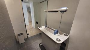 a bathroom with a white sink and a mirror at Hotel Royal Garden Kisarazu / Vacation STAY 72219 in Kisarazu