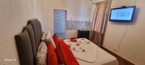 a room with a table and chairs and a television at Neo & Ruks Guest Houses Boston Belleville 5 in Bellville +28 photos