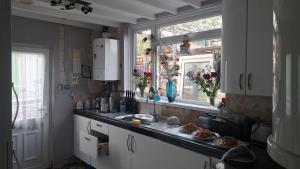 a kitchen with a counter and a window and a sink at The Old Chip Shop in Ilchester