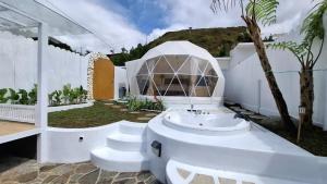 a white bathroom with a sink and a building at Himalaya 1 - Private Dome in Panjadakan