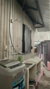a room with a television on the wall of a building at Happy Farm Homestay in Ấp Long Ðại