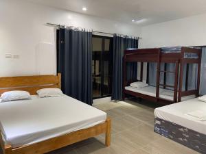 two beds in a room with two bunk beds at D'Horizon Mountain Resort in Samboan +28 photos
