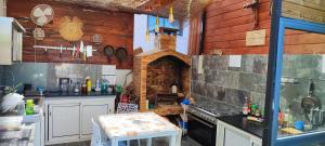 a kitchen with a stove and a brick oven at Villa Mary Guest House in Saint-André
