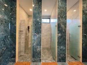 a bathroom with a shower with a glass door at สกายเบย์ เชียงคาน in Ban Pha Baen +146 photos