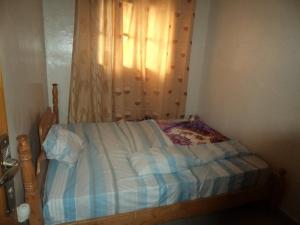 Ένα ή περισσότερα κρεβάτια σε δωμάτιο στο Best Home GuestHouse Musanze