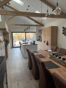 a large kitchen with a table and chairs in it at vakantiewoning Terminus in Beernem
