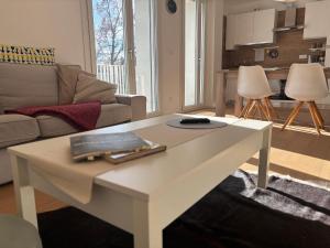 a living room with a white coffee table at Cozy Corner Treviso Station #4 in Treviso