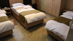 Ένα ή περισσότερα κρεβάτια σε δωμάτιο στο ASA Hotel