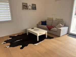a living room with a couch and a table at Cozy Corner Treviso Station #4 in Treviso