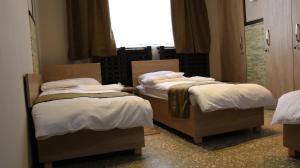 Ένα ή περισσότερα κρεβάτια σε δωμάτιο στο ASA Hotel