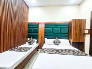 two beds in a room with two bedsvisor at Hotel Anjana Cottage - Stay 5 min Away From Golden Temple in Amritsar