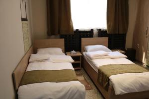 Ένα ή περισσότερα κρεβάτια σε δωμάτιο στο ASA Hotel