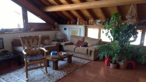 a living room with a couch and a table at B&B San Giorgio in Sovramonte
