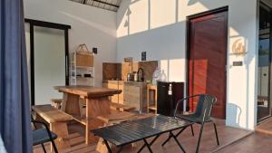 a kitchen with a table and chairs in a room at Private Cabin in Bandung