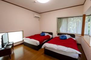 Letto o letti in una camera di Le Nessa Akazawa
