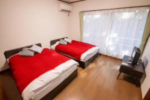 Letto o letti in una camera di Le Nessa Akazawa