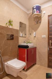 a bathroom with a toilet and a sink at The Micky House I Property of the year I Serviced Villa I Couple Friendly I Pvt Balcony I Open Air Terrace I Bonfire I Kasauli l Cloudberry By Exotic Stays in Dharampur +93 photos