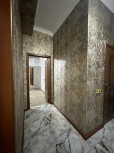 an empty room with a wall with a doorway at Narimanov Apartment in Baku +3 photos