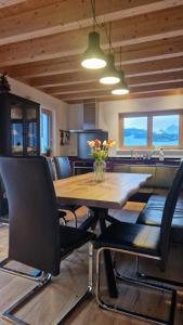 a dining room with a wooden table and chairs at Haus Alpengruss in Heiterwang