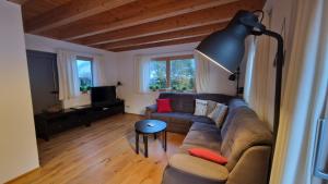 a living room with a couch and a table at Haus Alpengruss in Heiterwang