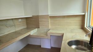 a small kitchen with a sink and a counter at Eagle's Nest Inn in Cabangusan