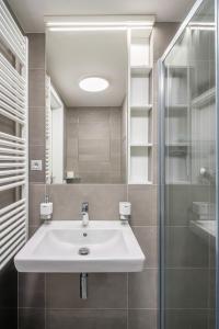 ブルノにあるNew apartment near the centre of Brnoの白い洗面台と鏡のあるバスルーム