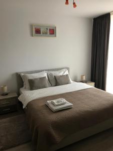 a bedroom with a large bed with a tray on it at Apartament Marcel - Coresi Mall in Braşov