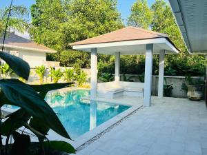 a gazebo sitting next to a swimming pool at Villa The Palm Sip Song in Koh Phangan