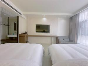 Giường trong phòng chung tại Zhangjiajie JoyMaple Hotel