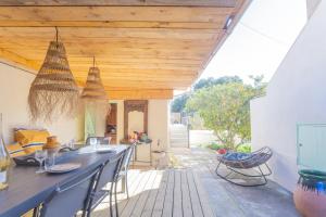 an outdoor patio with a bar with chairs and wooden ceilings at Le Terra'Ciel - Ciotat in La Ciotat