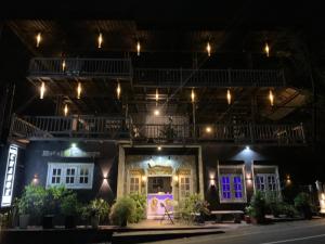 a house with purple and blue doors at night at Hotel Change in Badulla