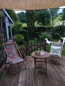 a patio with a table and chairs on a deck at la maison d'Anna chambres d hôtes in Ganac +24 photos
