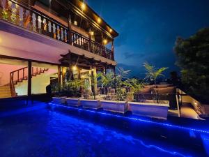 a house with a swimming pool at night at Timber House by Tara Group in Kathmandu