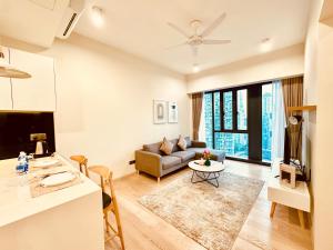 a living room with a couch and a table at Star Residence Suite KLCC in Kuala Lumpur