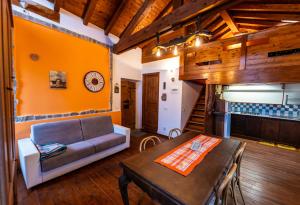 a living room with a couch and a table at Rustico verginate 3 in Bellano